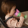 A young child holding the Insulated Sipper cup by Nuby.