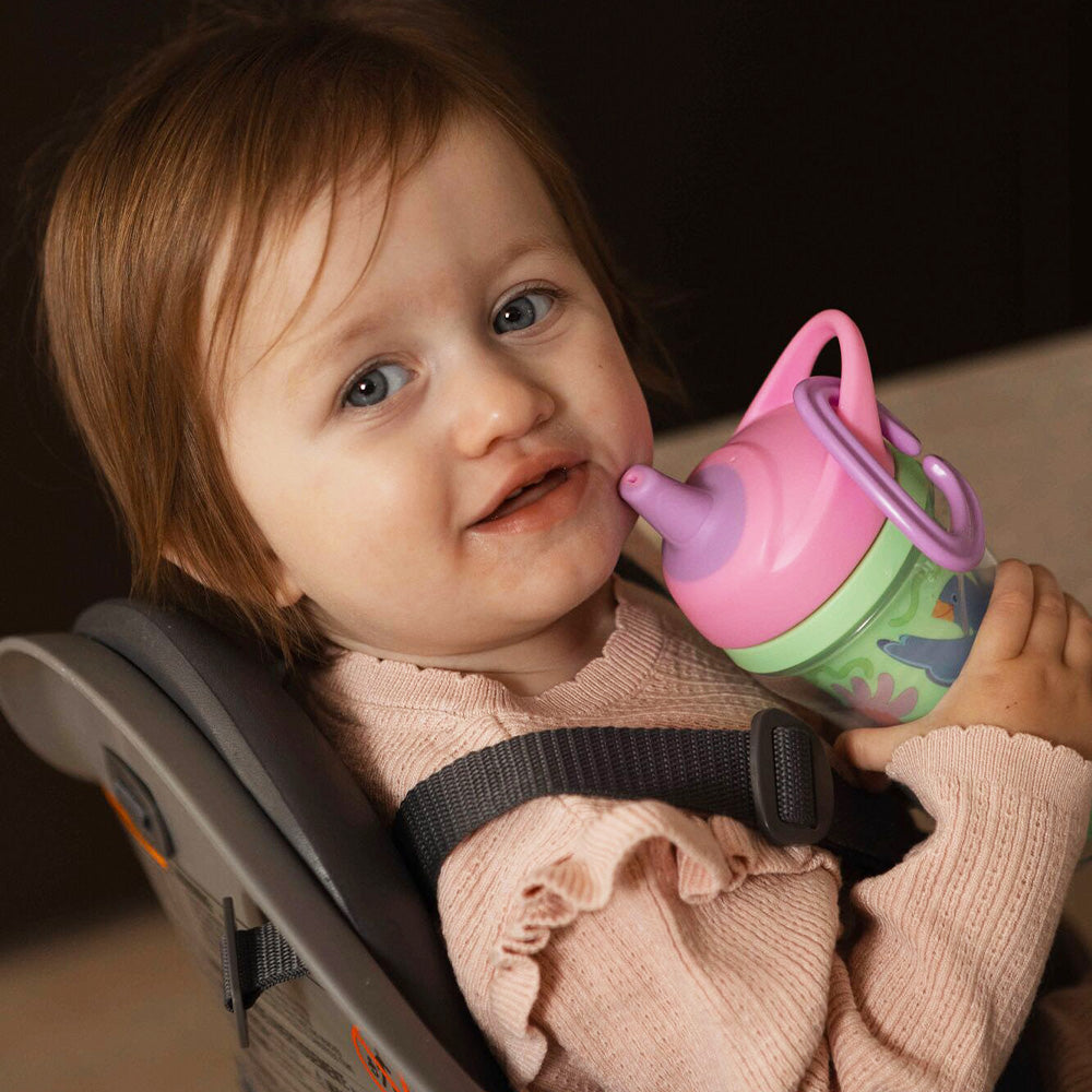 A young child holding the Insulated Sipper cup by Nuby.