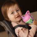 A young child holding the Insulated Sipper cup by Nuby.