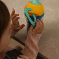 A young child holding the Insulated Sipper cup by Nuby.