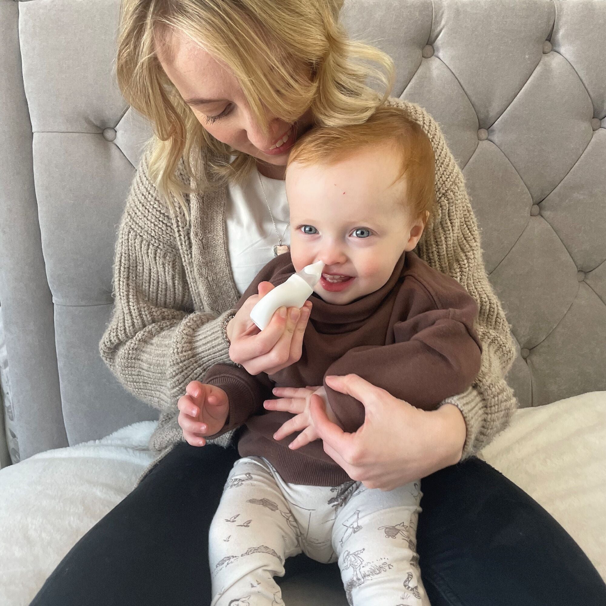 The Nasal Aspirator being used by a young child. A product by Nuby.