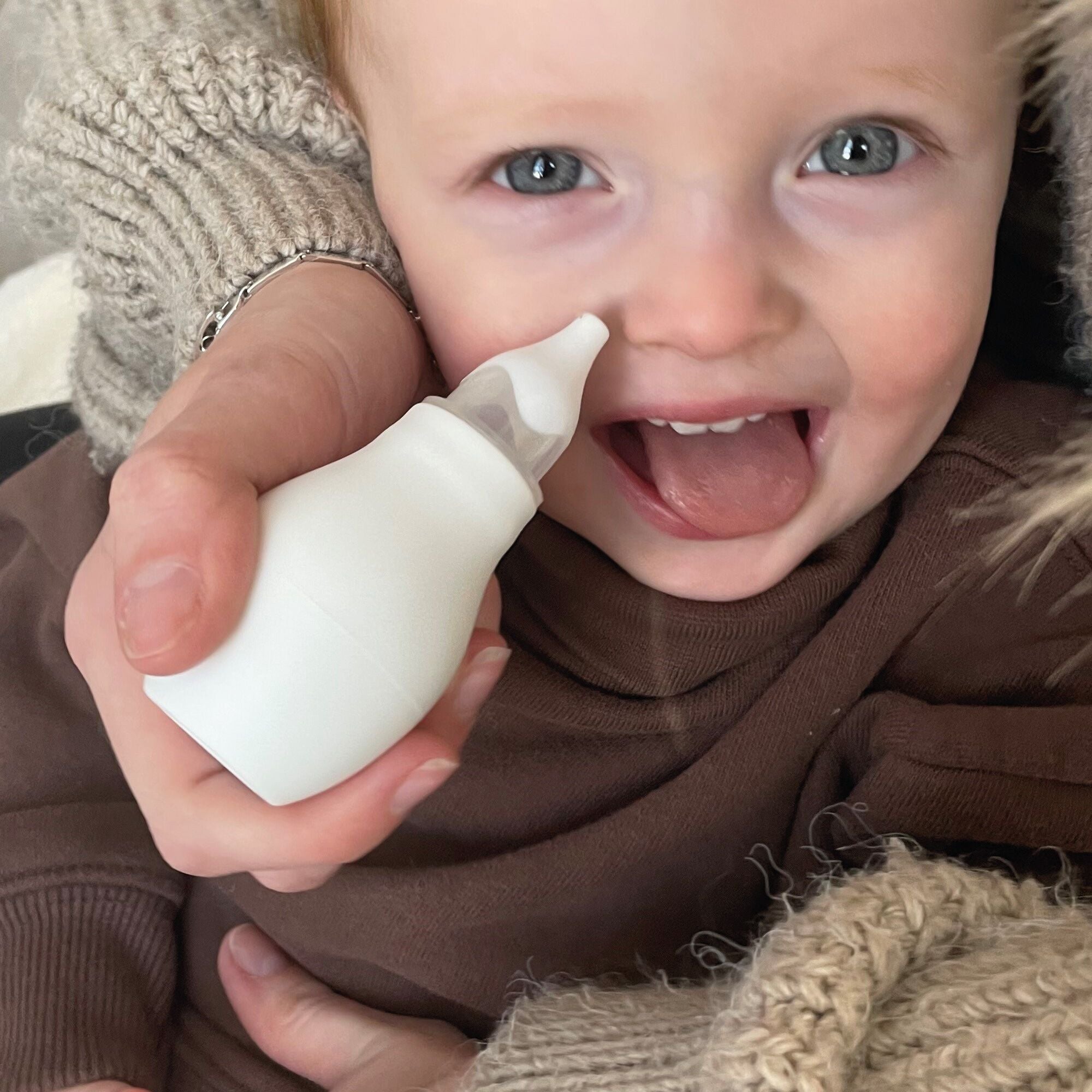 The Nasal Aspirator being used by a young child. A product by Nuby.