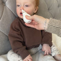 The Nasal Aspirator being used by a young child. A product by Nuby.