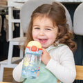 A baby using the Super Straw sippy cup from Nuby.