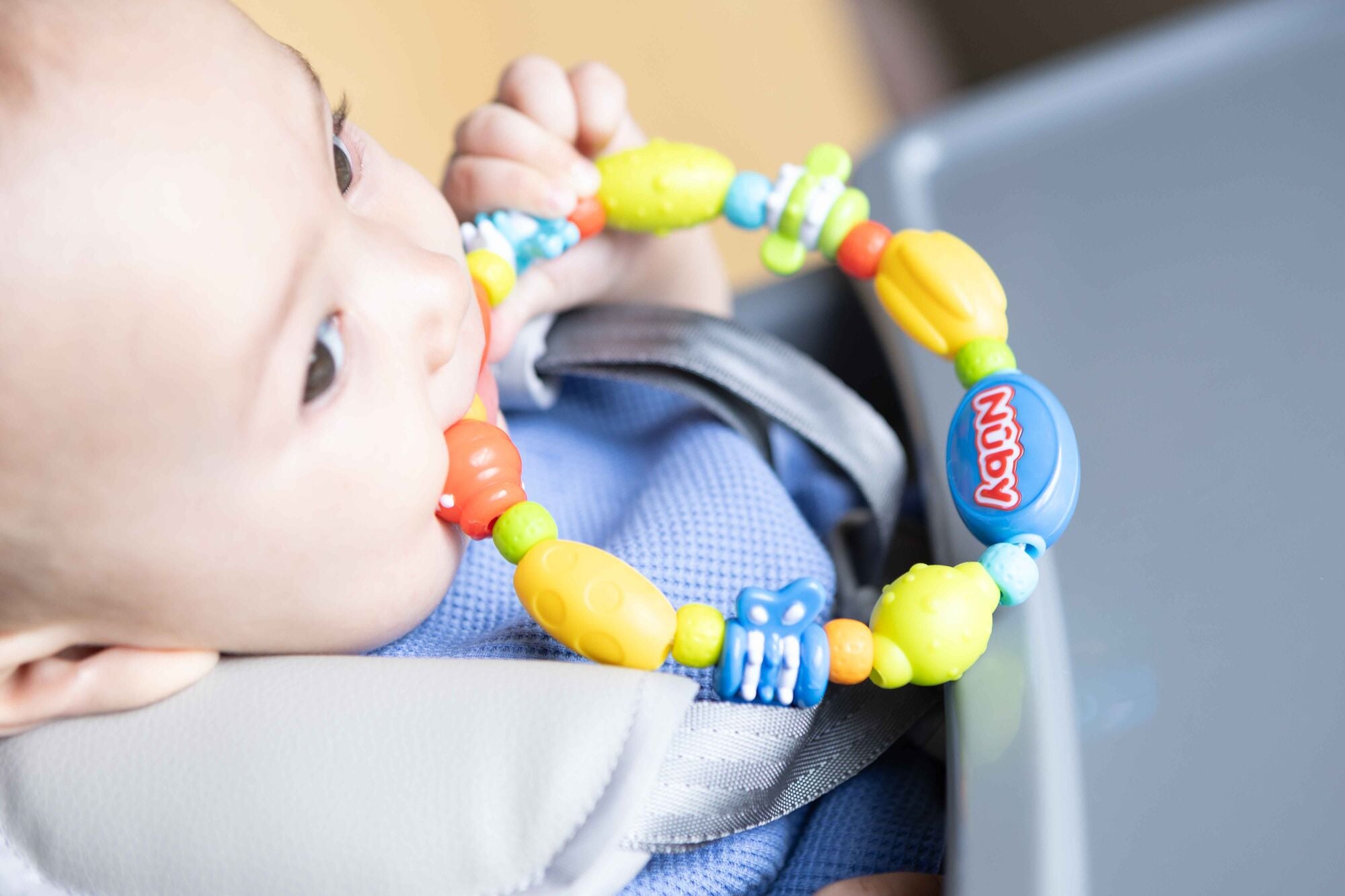 A Nuby teether, the bug a loop, with colourful characters for them to interact with when going through the teething process.