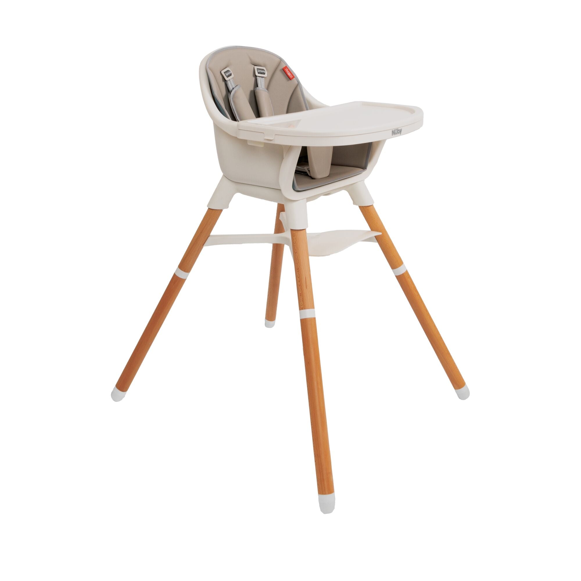 The Nuby UK 4-in-1 Multi-Use Highchair features a beige seat, safety harness, white tray, footrest, and light wooden legs with white tips—perfect for babies or toddlers.