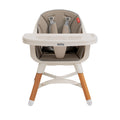 The Nuby UK 4-in-1 Multi-Use Highchair features a beige cushioned seat, safety harness, easy-clean white tray, and wooden legs with white tips, shown against a white background.