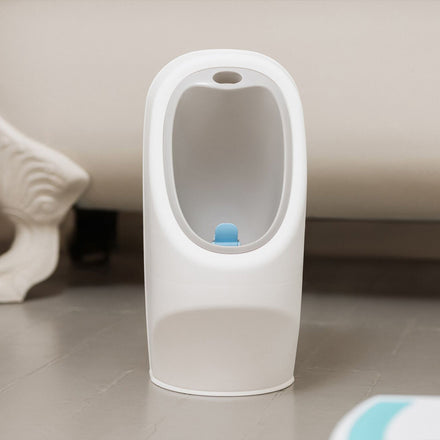 A photograph of the My Real Urinal created by Nuby, sat on a bathroom floor in front of a bath.