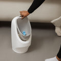 A My Real Urinal section being lifted from its' space. This is sat on a bathroom floor next to a bath.