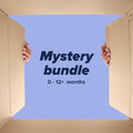 Hands open a large box with a blue background that reads “Mystery Baby Bundle”—a Nuby UK product filled with baby essentials for ages 0-12+ months.