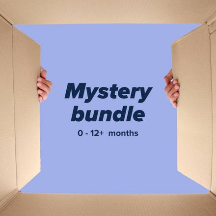 Hands open a large box with a blue background that reads “Mystery Baby Bundle”—a Nuby UK product filled with baby essentials for ages 0-12+ months.