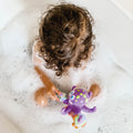 A child playing with the purple Octopus ring toy.