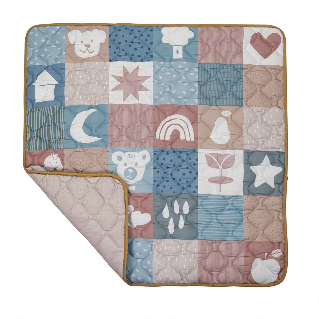 The Quilted Playmat features blue, pink, and beige patchwork with bear, heart, star, and moon designs. With a padded surface and a folded corner detail, it’s perfect for creating a cozy and playful area for your baby.