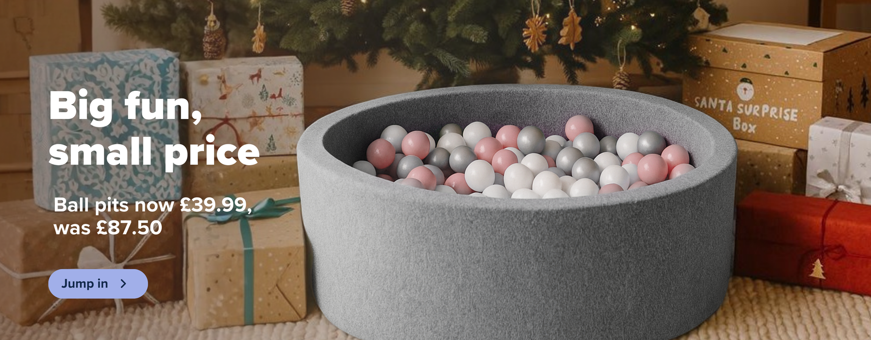 Ball pits now only £39.99, was £87.50. Perfect Christmas gift. Shop now. Banner showing a grey ball pit with pink and white balls, under a Christmas tree with presents. 