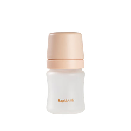 A 5oz RapidBottle Soft Touch Glass Baby Bottle, featuring a beige cap and "RapidBottle" in orange on the front, is shown against a plain white background.