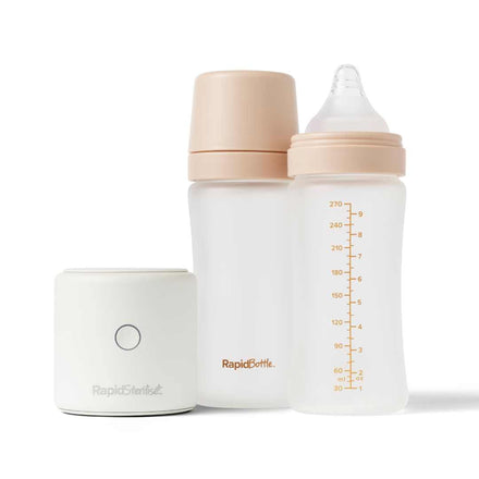The RapidBottles and RapidSteriliser+ Bundle includes a white portable bottle steriliser, a frosted borosilicate glass baby bottle with a tan cap, and another frosted bottle with a tan nipple and 270ml markings.