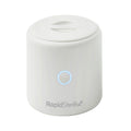 The compact, white RapidSterilise Plus UV Steriliser features a blue-lit circular button and flat lid, delivering fast, efficient sterilisation for baby bottles and more.