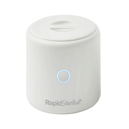 The compact, white RapidSterilise Plus UV Steriliser features a blue-lit circular button and flat lid, delivering fast, efficient sterilisation for baby bottles and more.