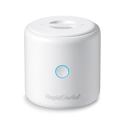 The compact, white RapidSterilise Plus UV Steriliser features a blue-lit circular button and flat lid, delivering fast, efficient sterilisation for baby bottles and more.