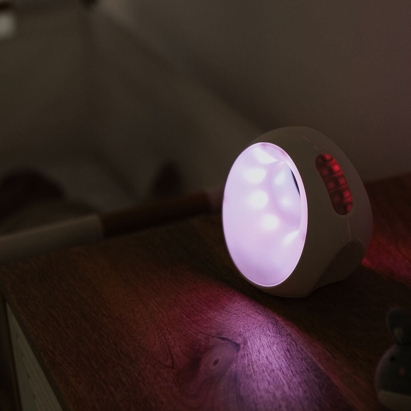 The sleep and sound by Nuby emitting a  purple or violet colour in a bedroom
