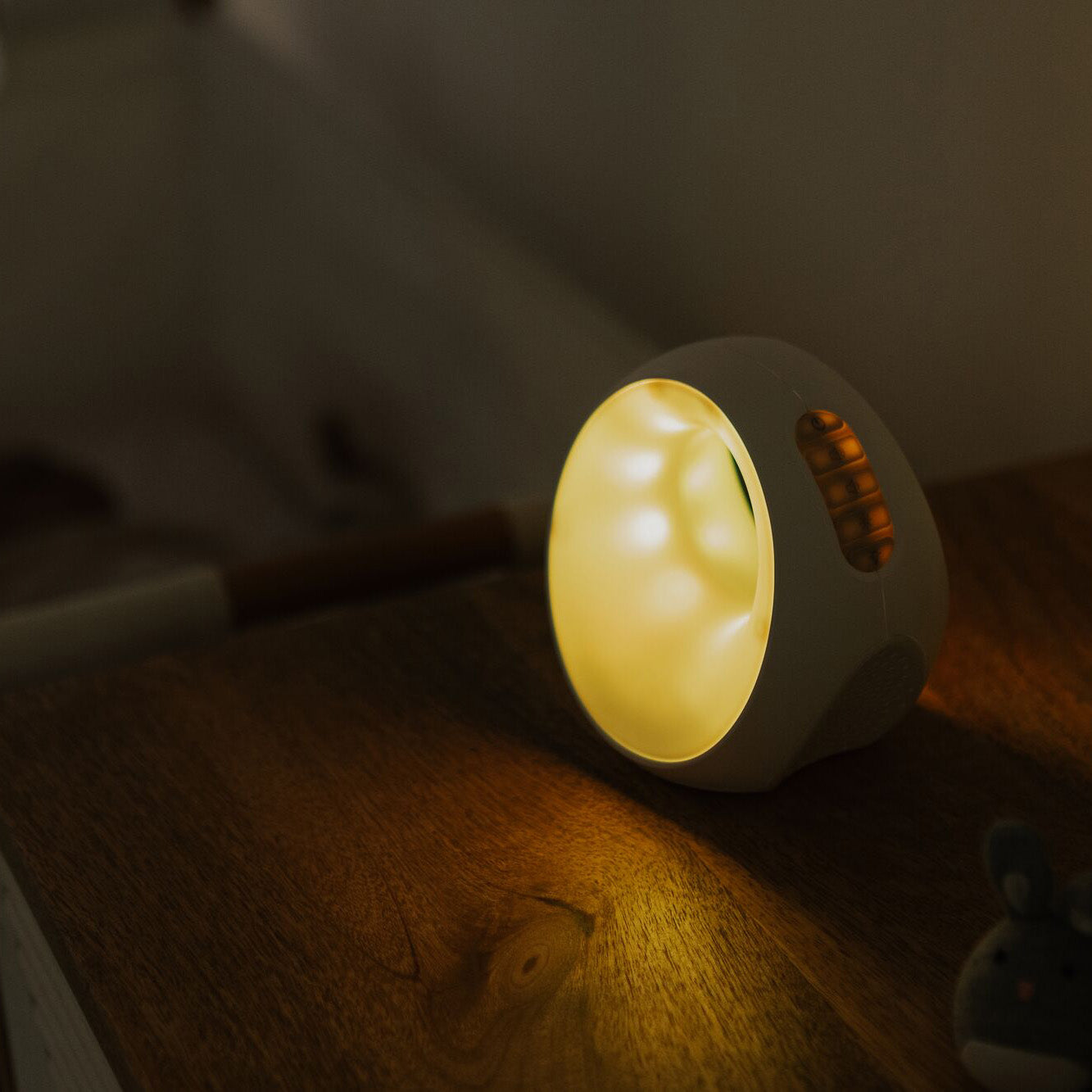 The sleep and sound by Nuby emitting a yellow colour in a bedroom