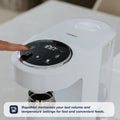 A hand presses a button on the Nuby UK Formula Making and Sterilising Bundle with a digital display. Text: RapidHot remembers your last volume and temperature settings for fast, convenient formula feeds—an essential for parents.