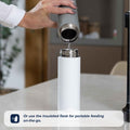 Pour water from the metal flask into the white insulated flask on your counter. Use the Nuby UK Formula Making and Sterilising Bundle for portable, on-the-go feeding—perfect for formula feeding essentials.