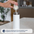 A hand pours premeasured formula powder into a white Nuby UK RapidCool from the Formula Making and Sterilising Bundle on a kitchen counter. Tip: Add formula powder to your RapidCool, then shake well to mix before feeding.