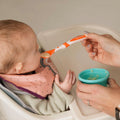 The orange spoon from Weaning Spoon by Nuby.
