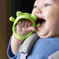 Wrist Pal Silicone Teething Mitt Teether Nuby   , a close up of the Baby chewing their Wrist Pal by Nuby.
