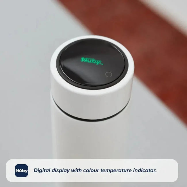 The Nuby RapidCool x Mul Limited Edition features a white bottle with a digital lid display showing the Nuby logo and temperature. The round black display stands out, with the background beautifully blurred.