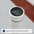 A white limited edition Nuby RapidCool x Mul baby bottle features a digital lid display showing the brand in green. Below, text reads: Digital display with colour temperature indicator—part of the RapidCool bottle range.