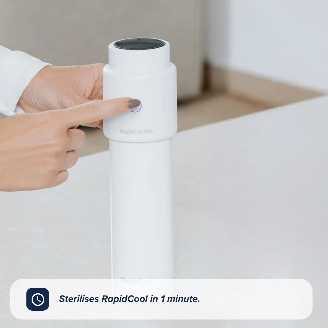 A hand presses the button on a white Nuby UK RapidSterilise Baby Bottle Maker Steriliser placed on a countertop. Text at the bottom reads, Sterilises RapidSterilise in 1 minute.
