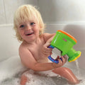 A smiling blonde child enjoys a bubble bath, playing with colorful Nuby UK baby bath toys—the perfect gift from the Baby Bath Sets for Newborns 0-12 Months for any baby shower or new arrival.