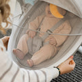 Protective cover net being used on the Nuby electric baby swing