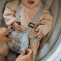 Securing baby into the Nuby swing chair harness
