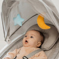 Baby seated comfortably in the Nuby swinging baby chair
