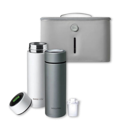 Two insulated bottles (white and gray) from the Nuby UK RapidCool™ Twin Pack and UV Steriliser Bundle stand before a gray handled case. The white bottle’s cap is off, displaying its inside and filter; a black and green device is close by.